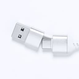A silver USB drive with dual connectors, one standard USB and one USB-C, featuring a sleek design and a logo.