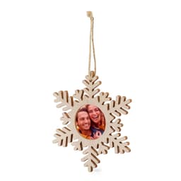 A wooden snowflake photo frame with a circular picture area, featuring a hanging twine. The frame is light in colour.