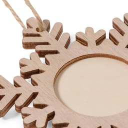 A wooden snowflake-shaped photo frame in natural tones, featuring a blank centre and a hanging string.