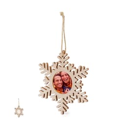 A wooden snowflake photo frame with an intertwined design, featuring a circular space for a photo and a hanging string.