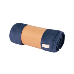 A rolled Durmok blanket in navy blue and tan, featuring a soft texture and a branding label.