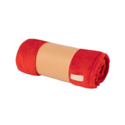 A rolled red blanket with a tan band and a small label. The blanket has a soft texture.
