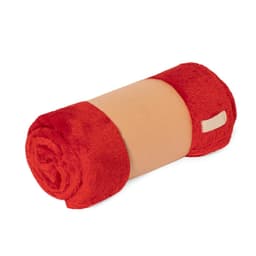 A rolled Durmok Blanket in red and beige, featuring a soft, plush texture and a branding logo.