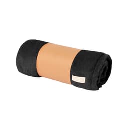 A rolled black and tan blanket with a soft texture and a small label, ideal for home use.
