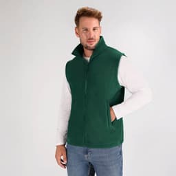 A green vest jacket with a high collar, featuring a front zipper and side pockets, worn by a model.