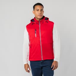 A red vest with a hood, featuring zippers and a front pocket, worn by a model. It has a logo on the chest.