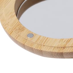 A circular mirror with a bamboo frame, featuring a small metal connector on the side.