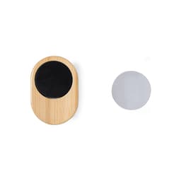 A wooden car phone holder with a black circular base and a separate silver metal disc.