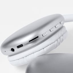 Silver headphones with white padding, featuring buttons, a USB-C port, and a headphone jack.