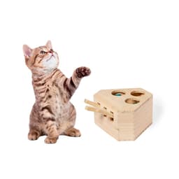 A playful tabby cat reaches for a wooden cheese-shaped toy with holes and sliding pieces, designed for games.