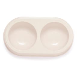 A double bowl pet feeding dish in a creamy beige colour, featuring a smooth design and an integrated base.