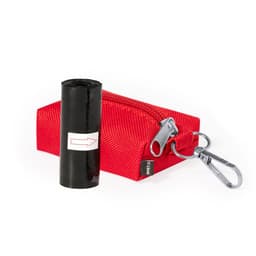 A red waste bag dispenser with a clip and a roll of black waste bags inside. It features a zip closure.
