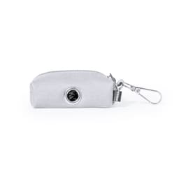 A grey waste bag dispenser with a clip for easy attachment, featuring a circular opening for easy access.