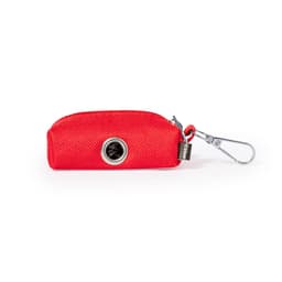 A red waste bag dispenser with a silver circular opening and a metal clip for attachment.