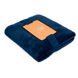 A folded navy blue blanket with a logoed tag and a matching ribbon. Suitable for home living use.