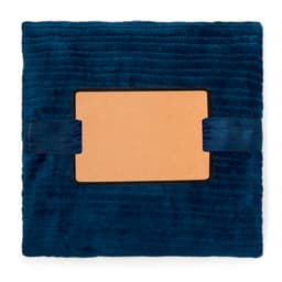 A deep blue Cindra Blanket featuring a smooth surface and a rectangular section with straps.
