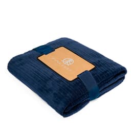 A navy blue blanket folded neatly, featuring a textured design and a branding label attached.