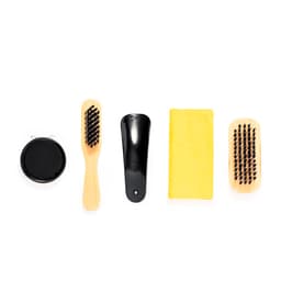 A hair care set featuring a wooden brush, a comb, a mirror, a shoehorn, and a yellow cloth.