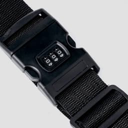 A black strap with a combination lock mechanism features a numeric dial for setting and changing the code.