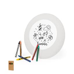 A round plate with a summer-themed design in the centre, surrounded by several colourful crayons and a small notepad.
