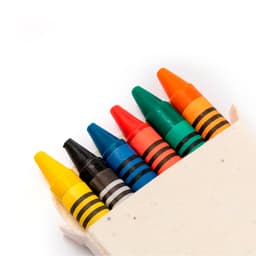 A box of crayons containing black, yellow, orange, red, green, and blue crayons, with a natural, unlabelled container.