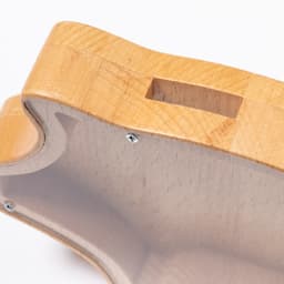 A wooden money box in light timber with a slot for coins and visible screws, featuring a smooth, curved design.