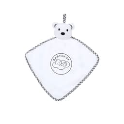 A plush toy in the shape of a white bear head on a diamond-shaped, grey and white comforter with a logo.