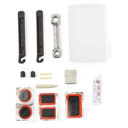 A bike repair kit featuring various tools, puncture patches, adhesive, and a carrying case in white and black.
