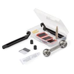 A repair kit for outdoor use featuring a transparent case, tools, adhesive, and various small components in black and silver.