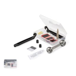 A compact repair kit contains various patches, adhesive, and a small wrench in a transparent case with a black handle.
