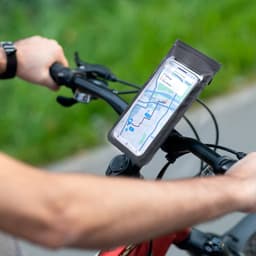 A grey phone pouch attached to a bike handlebar, displaying a map on the phone inside.