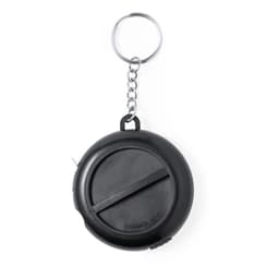 A black multi-tool tape measure with a keyring attachment. It features a circular design and a retractable measuring tape.