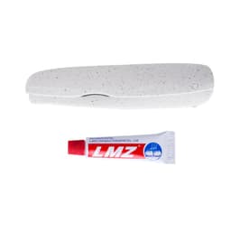 A white dental care kit featuring a toothbrush holder and mint toothpaste tube. The holder has a speckled design.
