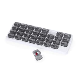 A pill organiser with grey compartments, labelled from day 1 to day 31, in a white tray. One compartment is open with a red capsule.