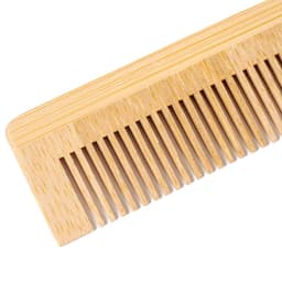 A bamboo comb with a smooth finish, featuring multiple fine teeth for grooming. It has a natural wood colour.