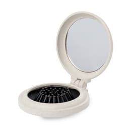 A compact mirror with a light beige exterior and a reflective surface, featuring a slot for tools or accessories.