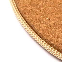 A cork product with a woven beige edge, suitable for home use. It features a round shape and natural texture.