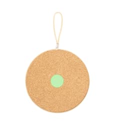 A circular cork holder in a natural beige colour with a mint green centre, featuring a zip and a loop handle.