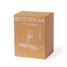 A boxed water fountain with a simple design, featuring a clear water flow and decorative stones. Brown cardboard packaging included.