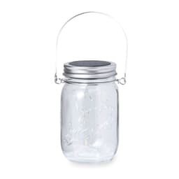 A clear glass lamp with a silver lid and handle, featuring decorative string lights inside.