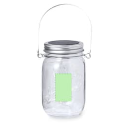 A clear glass lantern with a metal handle and silver lid, featuring a blank green label.