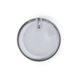 A clear, circular lapel pin with a shiny silver backing, featuring a smooth surface.
