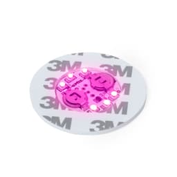 A round pink coaster with embedded LED lights, featuring a white base and a visible logo.