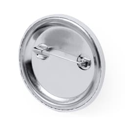 A silver button badge with a pin attachment on the back, featuring a smooth, shiny surface.