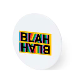 A round white button badge featuring vibrant striped text in various colours with "BLAH" printed on it.