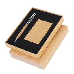 A wooden gift box containing a pen and a business card holder, both with a natural finish, featuring a black padding.