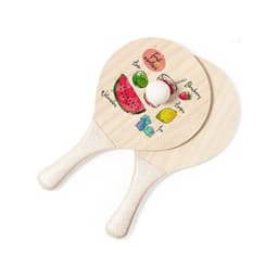Two wooden beach rackets featuring colourful fruit graphics and a white ball between them. Each racket has a handle.