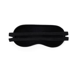 A black sleep mask with elastic bands for securing it in place. Features a smooth texture and contoured shape.