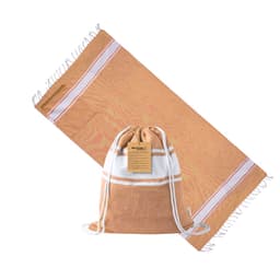 A beige and white drawstring bag with a matching towel laid out beside it, featuring a logo on the bag.