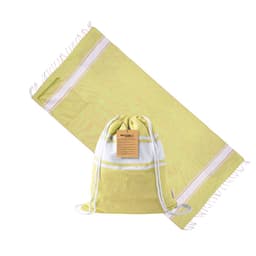 A green and white Carey drawstring bag laid beside a matching towel, featuring a simple design and a branding tag.